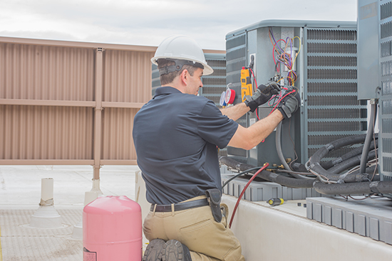 commercial hvac condenser check with technician