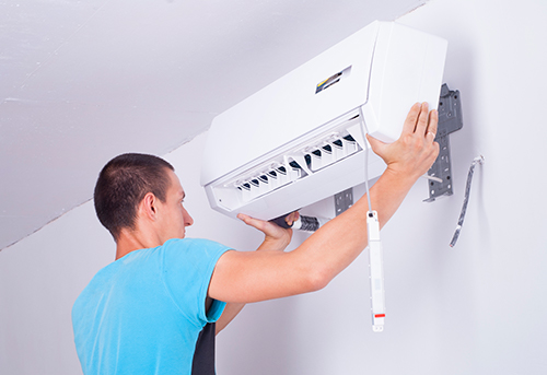 modern air ac technician mounting ductless ac system
